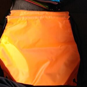 Two orange drawstring bags  